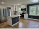 Modern kitchen featuring stainless steel appliances, white cabinets, and a central island with a marble countertop at 423 S Rhyne St, Dallas, NC 28034