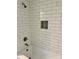The updated bathroom shower is tiled, and has a built-in shelf at 423 S Rhyne St, Dallas, NC 28034