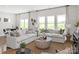 Bright living room with neutral decor, large windows offering scenic views, and comfortable seating at 426 Bent Burr Crk, York, SC 29745