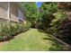Long, well-maintained backyard with lush green grass and mature trees offers a serene outdoor space at 4429 Cameron Oaks Dr, Charlotte, NC 28211