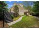 Beautifully landscaped backyard featuring a stone pathway, stairs, and manicured lawn at 4429 Cameron Oaks Dr, Charlotte, NC 28211