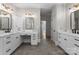 Modern bathroom with double sinks, white cabinets, and large mirrors at 4429 Cameron Oaks Dr, Charlotte, NC 28211