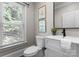 Stylish powder room featuring a modern vanity and natural light at 4429 Cameron Oaks Dr, Charlotte, NC 28211