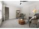 Comfortable bedroom with a wood center table and plush chairs at 4429 Cameron Oaks Dr, Charlotte, NC 28211