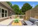 Open deck with a wooden railing and privacy screen offers views of the lush backyard and the house at 4429 Cameron Oaks Dr, Charlotte, NC 28211