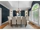 Formal dining room featuring paneled walls, built-in cabinets and a statement chandelier at 4429 Cameron Oaks Dr, Charlotte, NC 28211