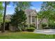 Elegant home with a circular driveway, mature trees, and well-maintained lawn at 4429 Cameron Oaks Dr, Charlotte, NC 28211