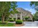 Stately home featuring an elegant facade with grand entryway and manicured landscaping at 4429 Cameron Oaks Dr, Charlotte, NC 28211