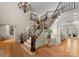 Elegant foyer featuring a curved staircase, chandelier, and hardwood flooring at 4429 Cameron Oaks Dr, Charlotte, NC 28211