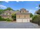 Spacious two-car garage with an asphalt driveway and traditional exterior lighting at 4429 Cameron Oaks Dr, Charlotte, NC 28211
