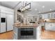 Modern kitchen with stainless steel appliances, granite countertops, a central island, and convenient stairs access at 4429 Cameron Oaks Dr, Charlotte, NC 28211