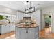 Bright kitchen featuring a central island, sleek countertops, custom cabinetry, and modern stainless steel appliances at 4429 Cameron Oaks Dr, Charlotte, NC 28211