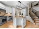 Modern kitchen with stainless steel appliances, granite countertops, a central island, and convenient stairs access at 4429 Cameron Oaks Dr, Charlotte, NC 28211