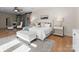Bright main bedroom features wood floors, ceiling fan, sitting area, and stylish furnishings at 4429 Cameron Oaks Dr, Charlotte, NC 28211