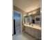 Bathroom featuring tiled floors, white vanity, and striped wallpaper at 504 Johnsfield Rd, Shelby, NC 28150
