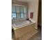 Large bathroom with a big soaking tub under a window, providing a relaxing atmosphere at 504 Johnsfield Rd, Shelby, NC 28150