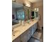 Bright primary bathroom with a double sink vanity, a large mirror, and jetted soaking tub beneath a window at 504 Johnsfield Rd, Shelby, NC 28150
