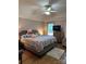 Spacious bedroom featuring a bed with patterned bedding, ceiling fan, and a window offering plenty of natural light at 504 Johnsfield Rd, Shelby, NC 28150