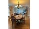 Cozy dining room featuring hardwood floors, elegant chandelier, and seamless open floor plan to living room, perfect for entertaining at 504 Johnsfield Rd, Shelby, NC 28150