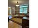 Comfortable office area features a sectional couch, built in cabinet with laminate top and hardwood floors at 504 Johnsfield Rd, Shelby, NC 28150
