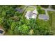 Private backyard with a sparkling pool surrounded by lush greenery and a full fence at 5252 Ramblewoods Ave, Claremont, NC 28610