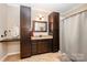 Bathroom featuring dark wood cabinetry, granite countertops, and a shower with curtain at 5252 Ramblewoods Ave, Claremont, NC 28610