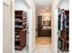 Bathroom situated between closets with dark wood cabinetry and warm neutral tones at 5252 Ramblewoods Ave, Claremont, NC 28610
