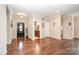 Inviting foyer with hardwood floors, neutral walls, and a view of the adjacent bathroom with updated vanity at 5252 Ramblewoods Ave, Claremont, NC 28610