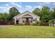 Charming single-Gathering home boasts a well-manicured lawn and cozy, covered front porch with brick steps at 5252 Ramblewoods Ave, Claremont, NC 28610