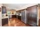 Well-equipped kitchen with stainless steel appliances, dark wood cabinetry, and an adjacent breakfast area at 5252 Ramblewoods Ave, Claremont, NC 28610
