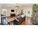 Bright living room featuring vaulted ceilings, hardwood floors, and French doors leading to the outdoors at 5252 Ramblewoods Ave, Claremont, NC 28610