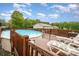 Backyard featuring a private pool surrounded by a wooden deck and lounge chairs at 5252 Ramblewoods Ave, Claremont, NC 28610