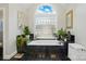 Bright bathroom with a garden tub, glass block window and plants, providing a tranquil and spa-like atmosphere at 5718 Bardsey Ct, Matthews, NC 28104