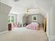 Spacious bedroom with neutral carpet, a ceiling fan, and natural light from multiple windows at 5718 Bardsey Ct, Matthews, NC 28104