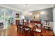 Formal dining room with hardwood floors, elegant chandelier, and classic furnishings at 5718 Bardsey Ct, Matthews, NC 28104