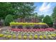 Community entrance with brick sign and colorful floral landscaping at 5718 Bardsey Ct, Matthews, NC 28104