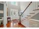 Grand foyer with gleaming hardwood floors, elegant staircase, and a beautiful front door at 5718 Bardsey Ct, Matthews, NC 28104