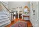 Spacious foyer featuring hardwood floors, staircase, and views into the formal dining room at 5718 Bardsey Ct, Matthews, NC 28104