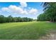 Picturesque view of a pristine golf course with lush green fairways and mature trees at 5718 Bardsey Ct, Matthews, NC 28104