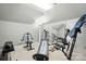 Home gym equipped with a Total Gym XL and weights, providing a convenient and private fitness space at 5718 Bardsey Ct, Matthews, NC 28104