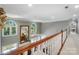 Bright hallway overlooking the living room, featuring hardwood floors and elegant white railings at 5718 Bardsey Ct, Matthews, NC 28104