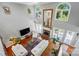 Open-concept living room with hardwood floors, tall windows, and a fireplace, viewed from above at 5718 Bardsey Ct, Matthews, NC 28104