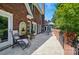 Covered patio with brick accents, an outdoor seating area, and well-maintained landscaping at 5718 Bardsey Ct, Matthews, NC 28104