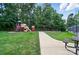 Community playground with swings and slides, surrounded by green space at 5718 Bardsey Ct, Matthews, NC 28104
