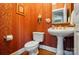 Stylish powder room with elegant fixtures, decorative mirror, and patterned wallpaper at 5718 Bardsey Ct, Matthews, NC 28104