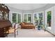 Bright sitting area with a chaise lounge, large windows, and an antique desk providing a cozy and inviting space at 5718 Bardsey Ct, Matthews, NC 28104
