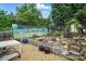 Landscaped backyard features a greenhouse, rock garden, and patio set for enjoying the outdoors at 6221 Thermal Rd, Charlotte, NC 28211