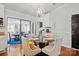 Cozy dining area with a round glass table, comfortable chairs, and modern chandelier at 6221 Thermal Rd, Charlotte, NC 28211