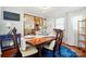 Elegant dining room with wood table, stylish chairs, and sliding glass doors at 6221 Thermal Rd, Charlotte, NC 28211