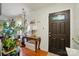 Inviting entryway featuring hardwood floors, elegant console table, and decorative door at 6221 Thermal Rd, Charlotte, NC 28211